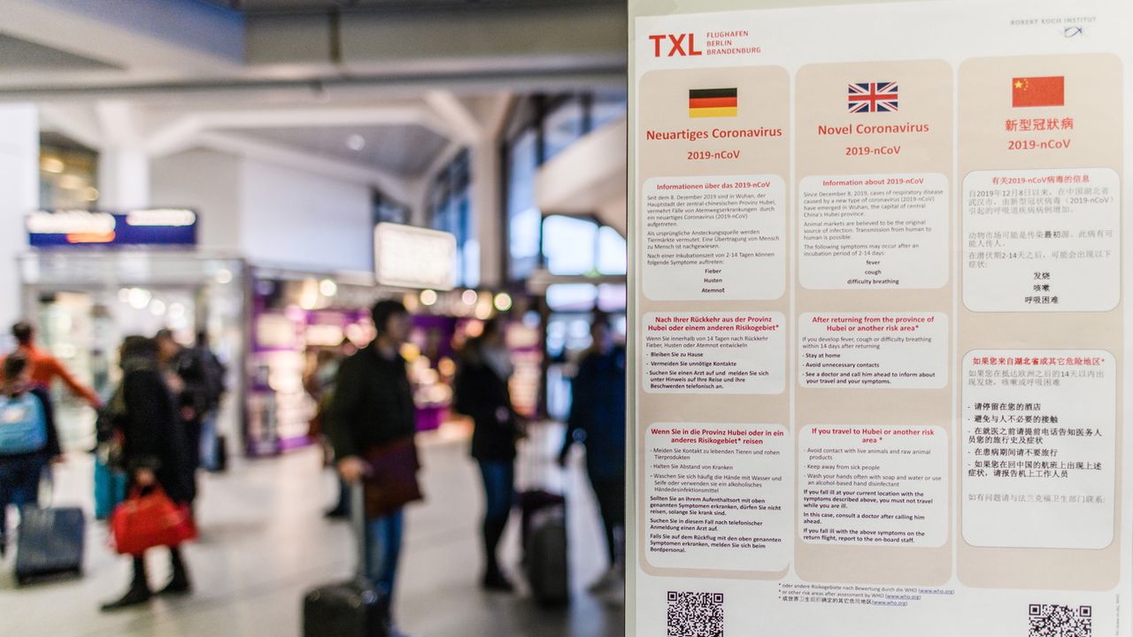 Des affiches renseignent les voyageurs sur les mesures de prévention en vigueur à l'aéroport de Berlin-Tegel [Clemens Bilan - Keystone/EPA]