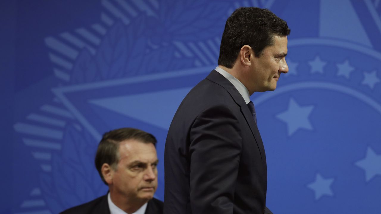 Sergio Moro tourne le dos au président Jair Bolsonaro. [Eraldo Peres - AP/Keystone]
