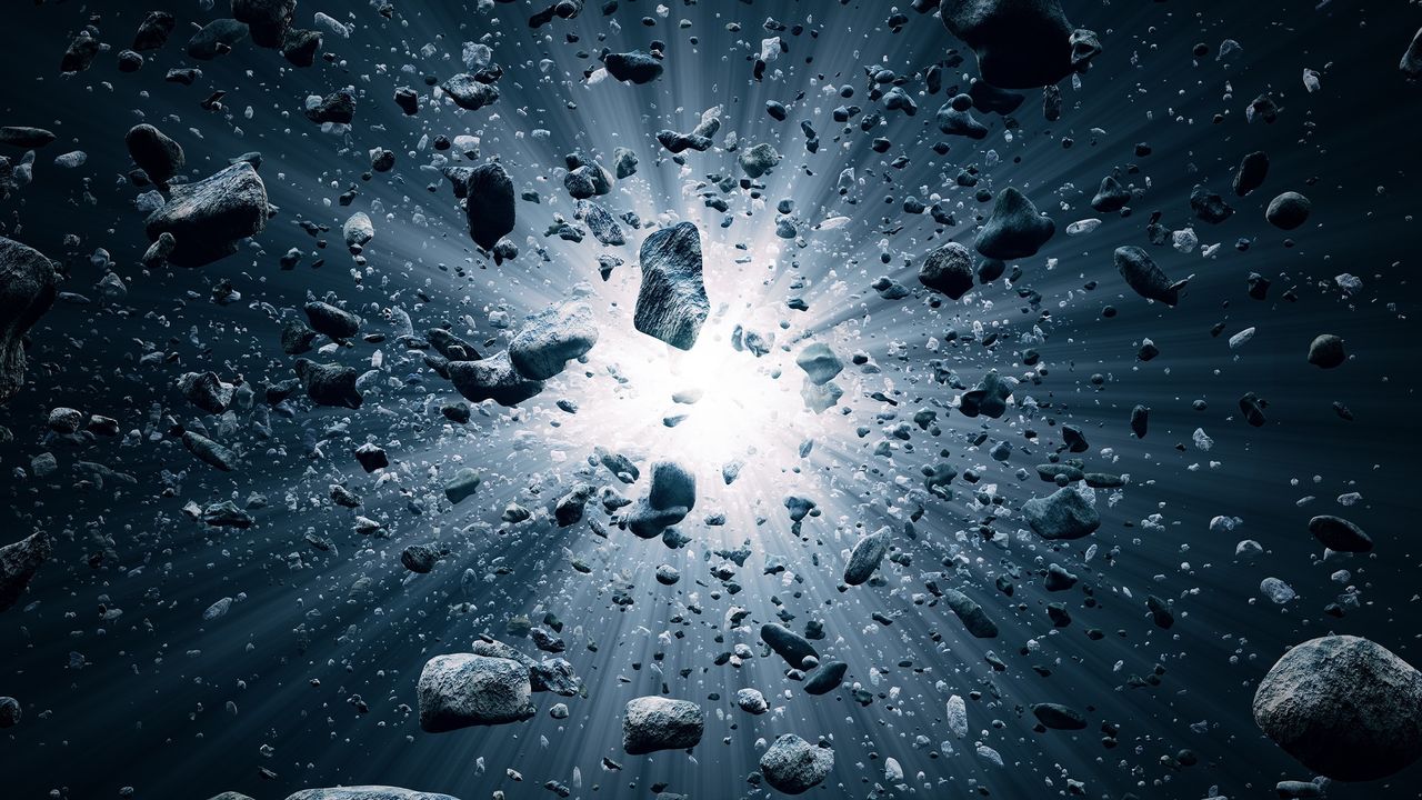 Roches et débris volant dans l’espace après l'explosion du Big Bang. [JohanSwanepoel - Depositphotos]