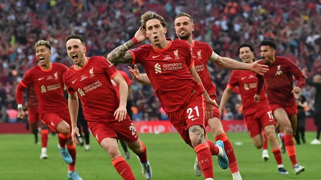 La joie et la rage des joueurs de Liverpool après le penalty victorieux de Kostas Tsimikas (au premier plan). [Glyn Kirk - AFP]
