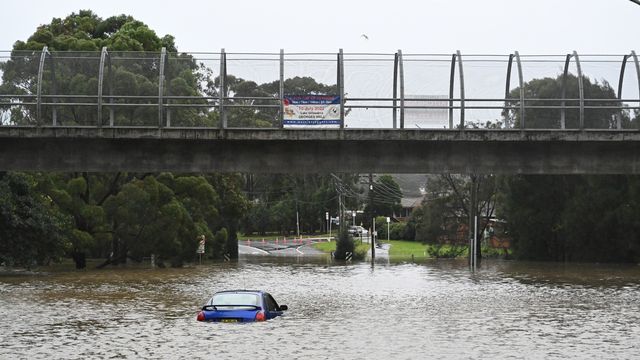 Une voiture est inondée dans les eaux de crue à Lansvale, dans l'ouest de Sydney, en Australie. [Mick Tsikas / EPA - KEYSTONE]