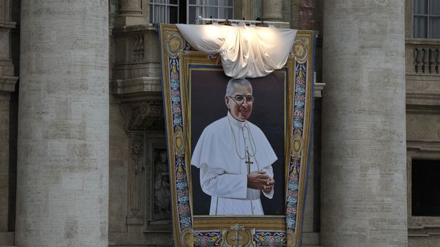 La tapisserie représentant le pape Jean-Paul 1er dévoilée sur la façade de la Basilique Saint-Pierre au Vatican. [Alessandra Tarantino - Keystone/AP Photo]