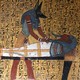 Représentation datant du règne de Ramsès II (1279-1213 avant J.-C.) du dieu Anubis s'occupant de la momie d'un ouvrier. Provenance: nécropole de Deir el-Medina à Thèbes, Égypte. Anubis est un dieu funéraire de l'Égypte antique, maître des nécropoles et protecteur des embaumeurs, représenté comme un grand canidé noir couché sur le ventre, sans doute un chacal ou un chien sauvage, ou comme un homme à tête de canidé.