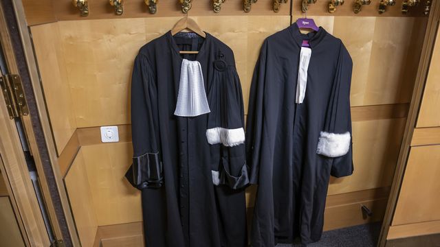 Deux robes d'avocat suspendues au portemanteaux du Palais de justice de Genève, 1er octobre 2022. [Martial Trezzini - Keystone]